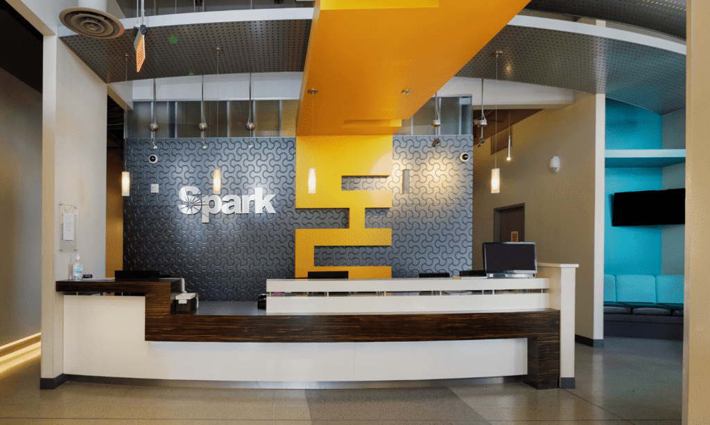 Spark Orthodontics Bethlehem office reception desk with Spark logo wall