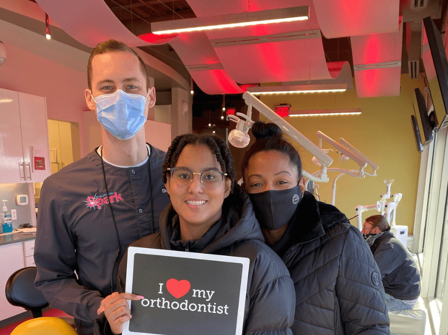 girl holding I love my orthodontist sign