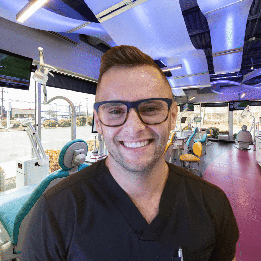 Dr. Brandon Smith smiling in the treatment area at Spark Orthodontics
