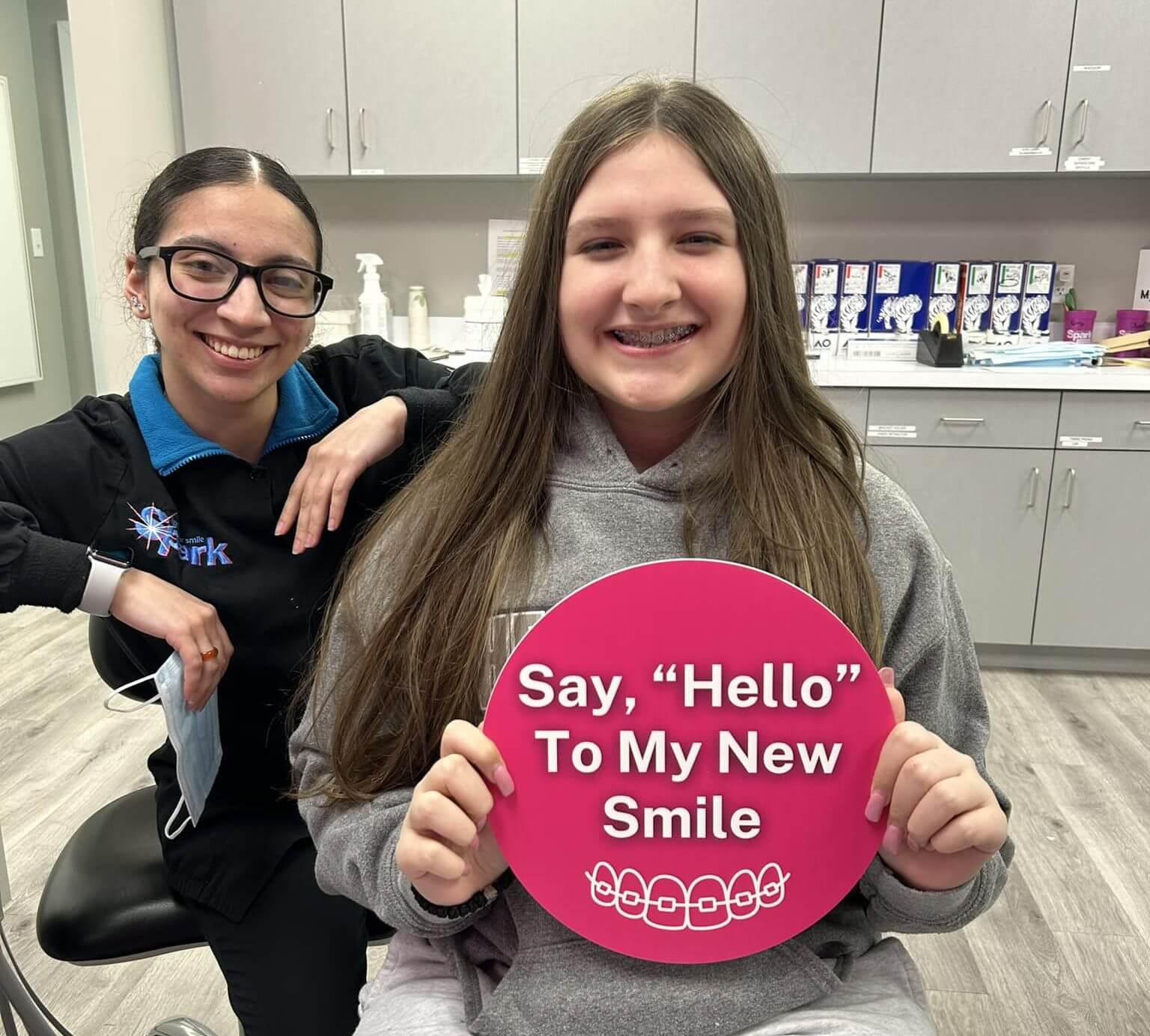 Patient holding a sign celebrating their new smile