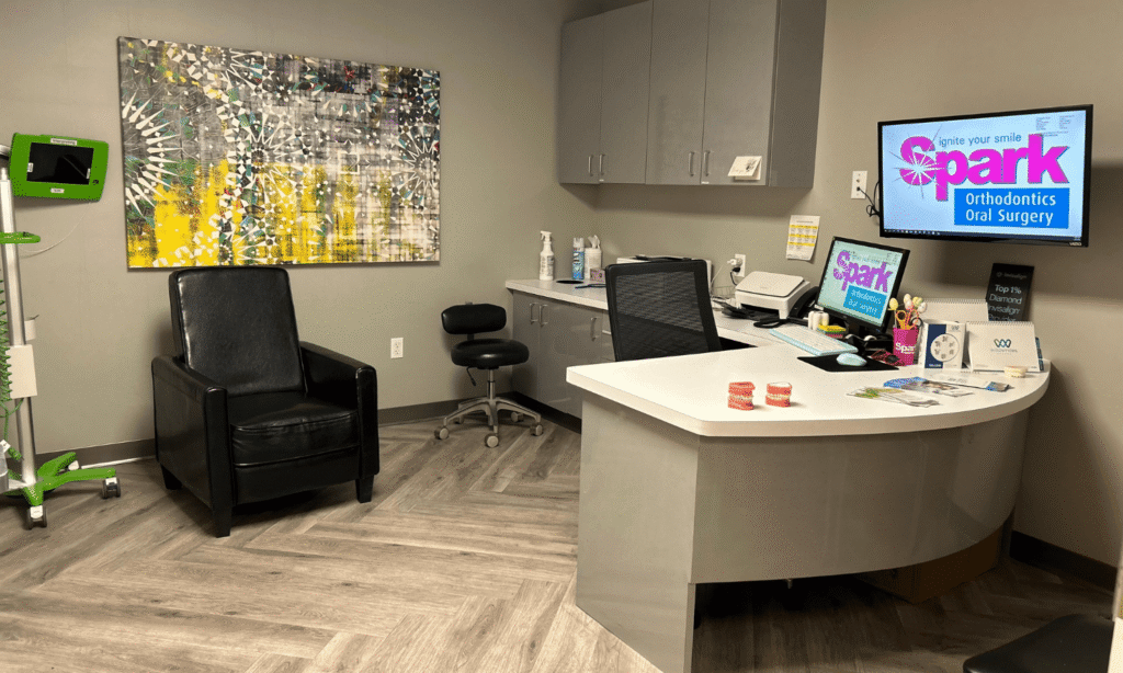 Front desk with a Spark Orthodontics logo displayed on a screen at the Danville, PA office