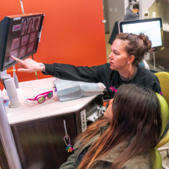 Staff member greeting a patient at the front desk