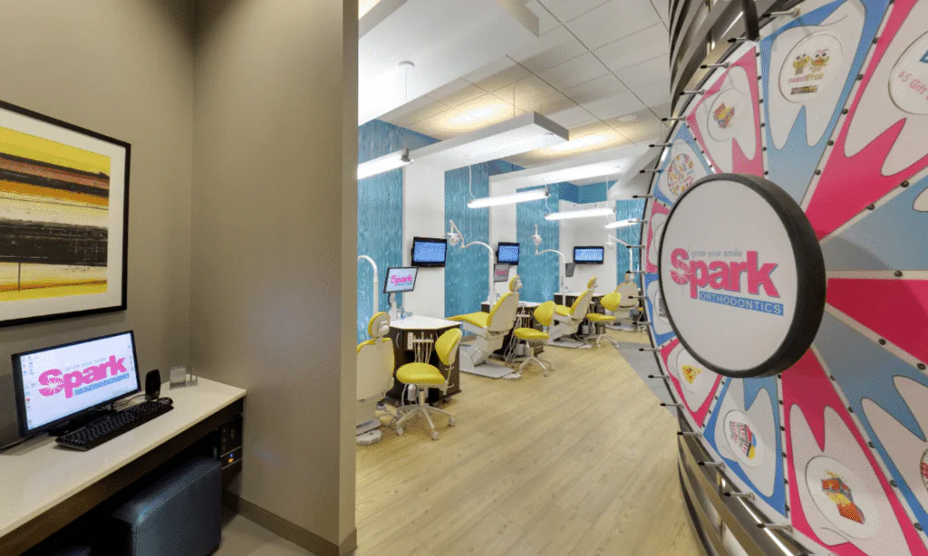 Open treatment bay with dental chairs and Spark logo wall art at the Spark Orthodontics Reading, PA office